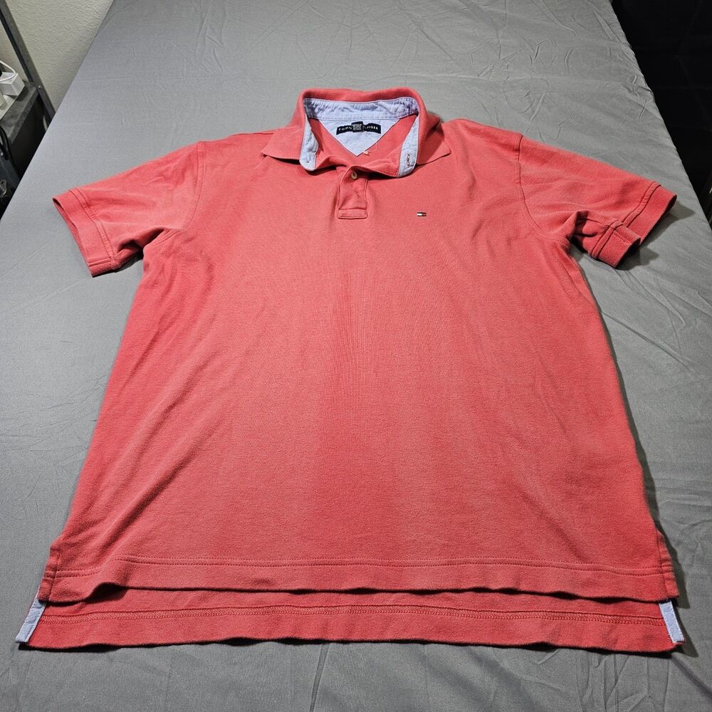 men's short-sleeve polo shirt by Tommy Hilfiger in a coral, salmon, or washed...